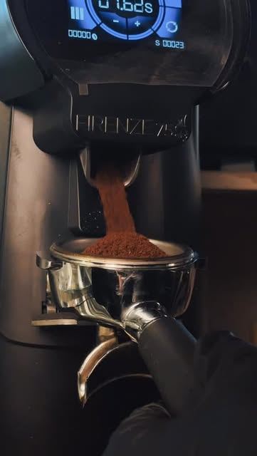 Fresh coffee being ground into a portafilter