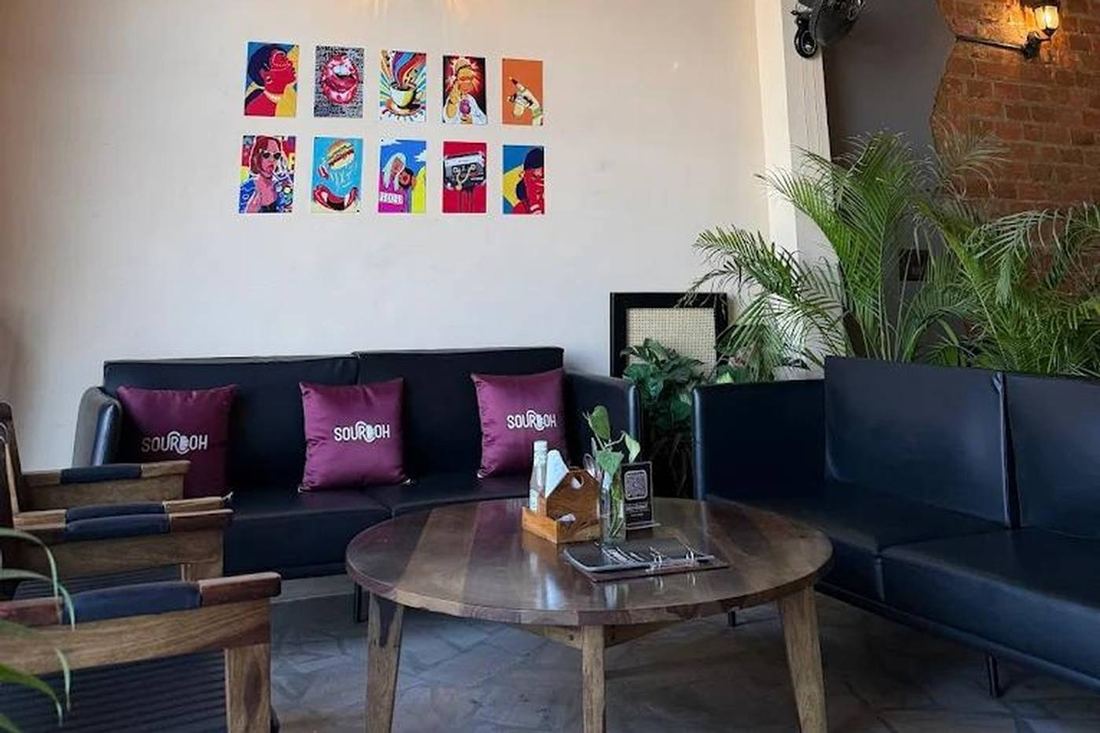 Sofa lounge with Gully Gourmet cushions and a round wooden table