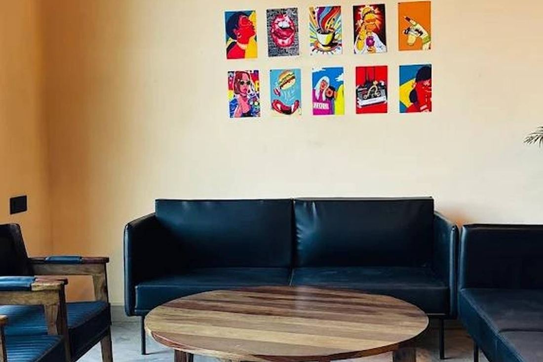 Leather sofa under a wall of colourful pop-art prints